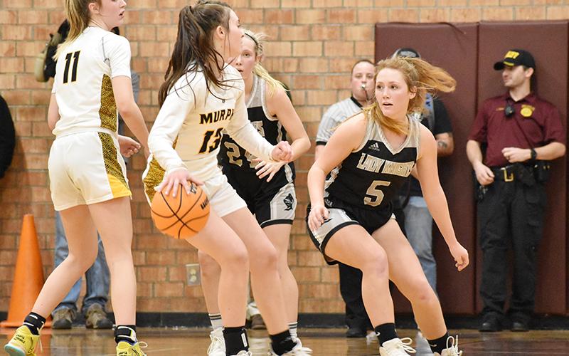 Robbinsville senior Halee Anderson (5) keeps tabs on Murphy's Addie Johnson during tonight's Smoky Mountain Conference Tournament finale at Swain County High School. Photo by Kevin Hensley/sports@grahamstar.com