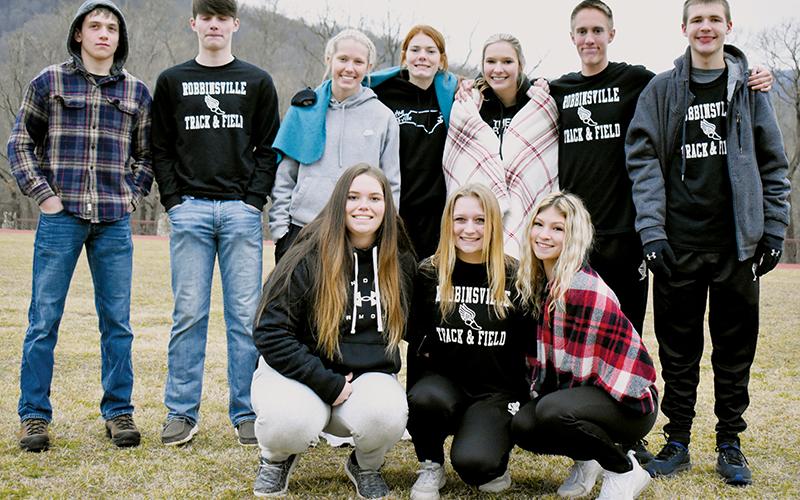 Robbinsville’s indoor track team bundled up and showed off at the Feb. 2 Smoky Mountain Conference championship meet in Cherokee. Kneeling in front (from left): Montana Buchanan, Haize Moore and Caylin Lunsford. Standing (from left): Caden Lail, Roman Jones, Kensley Phillips, Zoie Shuler, Delaney Brooms, William Cable and Zeb Stewart. Photo by Kevin Hensley/sports@grahamstar.com