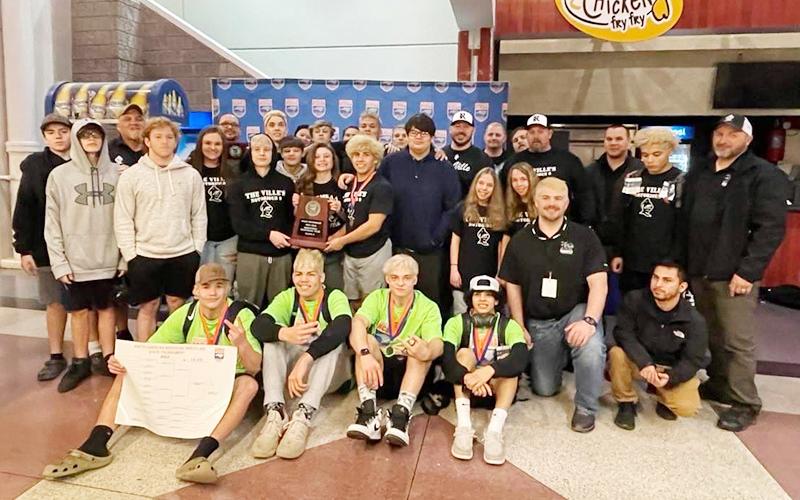 Several members of the Robbinsville wrestling program gather in the Greensboro Coliseum concourse Saturday night, posing with the 1A Invitational Tournament Team Runner-Up plaque. Photo courtesy of Susan Crowe/Contributing Photographer