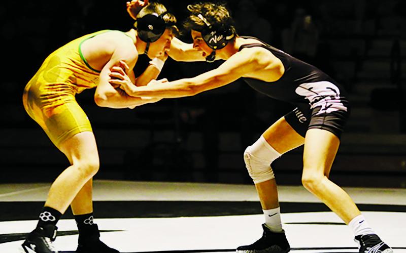 Robbinsville's Christian Phillips (right) jockeys for control with Alleghany's Cameron Worrick during Monday's second-round state dual against the Trojans. Photo by Miranda Buchanan/Robbinsville High School Yearbook