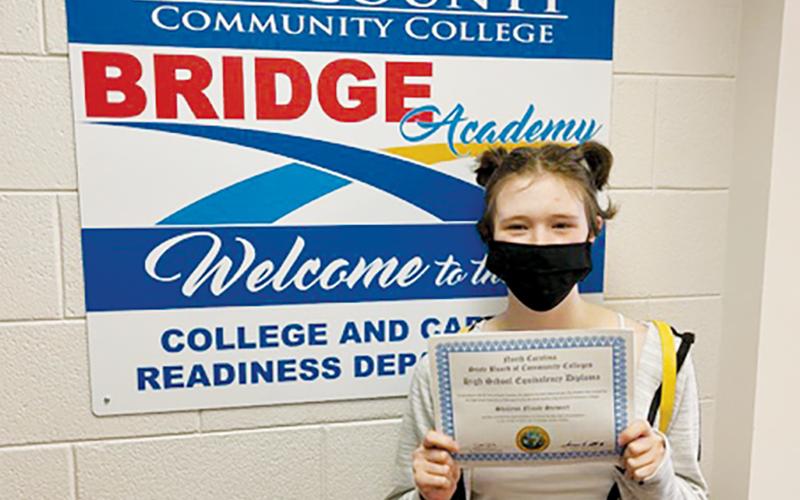 Shay Stewart poses with her high school equivalency diploma.