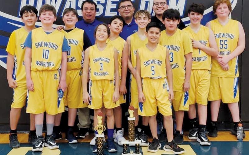 The Snowbird Mite Boys captured the 2021-22 Smokey Mountain Youth Conference tournament championship Feb. 5, after defeating Robbinsville in the title game. All names are listed from left. Front row: Whyatt Lewis, Hayden Lewis, Elijah Kirkland, Keni Wolf, Xamuel Wachacha, Elijah Lambert, Jayce Turner, Colby Kirkland, Avery Brown and Landon  Eddings. Back row: coaches Cody Teesateskie, Adam Wachacha and Zane Wachacha.