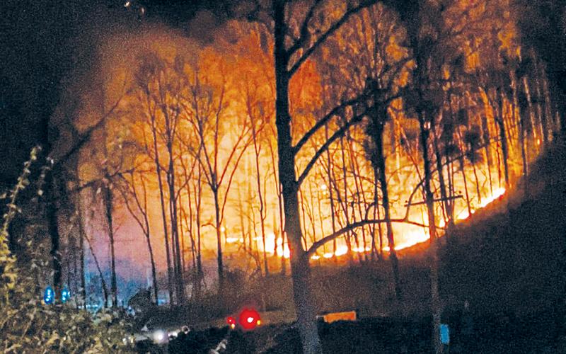 Dry, windy conditions over the weekend sparked wildfires all over the region. Here, a tree limb severed an electrical line at Fontana Dam on Saturday afternoon, leading to a blaze that lasted late into the night. Photo courtesy of Zelerie Rogers