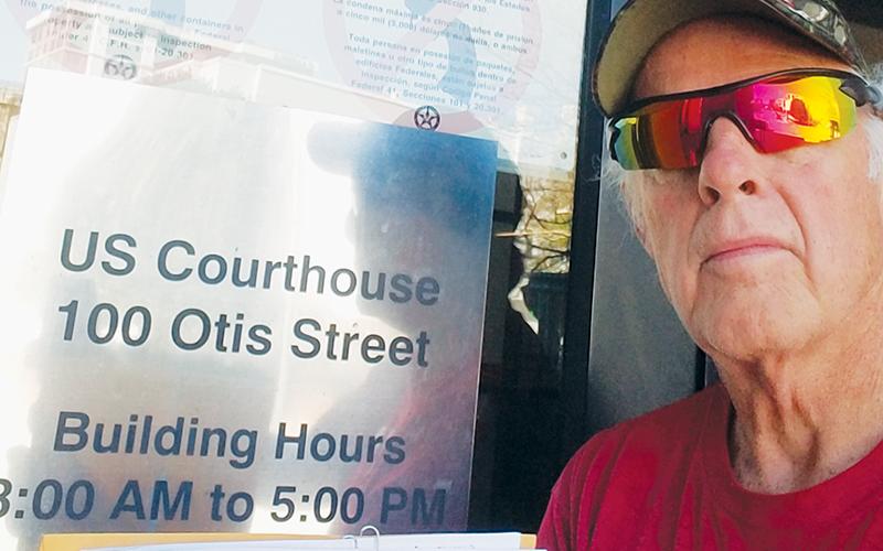 Gerry Laschober poses at the federal courthouse in Asheville on Monday, when he filed his response to a defendant’s motion to dismiss.