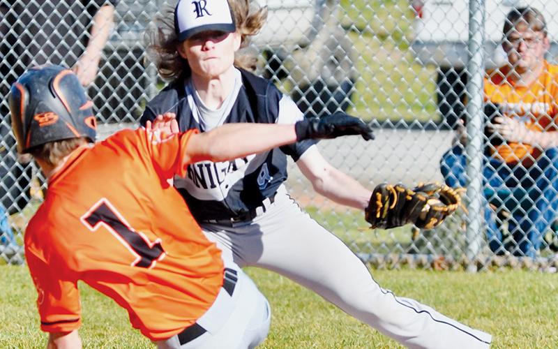 Kade Garrison waits to apply the tag to Rosman’s Aaron Eubanks during March 10’s home game. Photo courtesy of Raven Rattler/Robbinsville High School Yearbook
