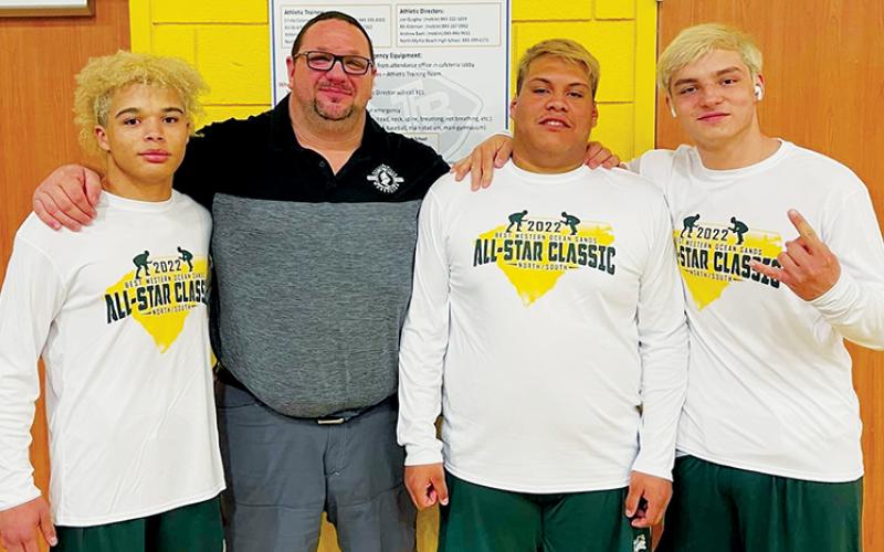 Members of “The ‘Ville” were selected for the N.C./S.C. All-Star Classic, which was held Friday in Myrtle Beach. From left are Jayden Nowell, Robbinsville head coach Todd Odom, Carlos Wesley and Kyle Fink. Photo by Susan Crowe/Contributing Photographer