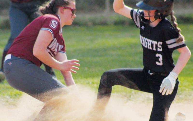 In a cloud of dust, middle school Lady Knight Daphne Barlow slides under the tag during Tuesday’s road loss to Swain County. Photo courtesy of Tyffany Hicks/Contributing Photographer
