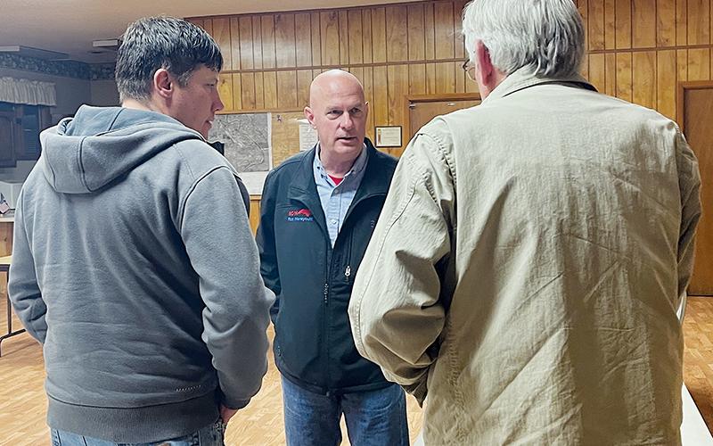 Rod Honeycutt speaks to Graham County Armed Patriots members Adam Phillips (left) and Kevin Haag during a March 1 stop in Robbinsville. Photo by Randy Foster/news@grahamstar.com