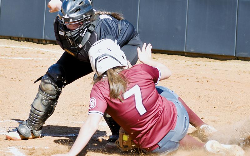 Robbinsville Middle School catcher Dreylee Webster applies the tag to a Swain County runner Friday. Photo by Kevin Hensley/sports@grahamstar.com