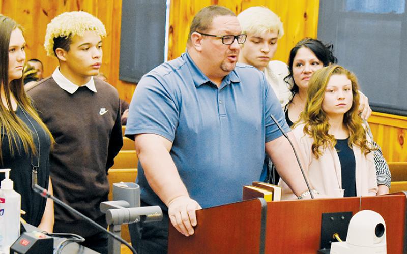 Robbinsville’s Todd Odom was inducted as an honorary member of the Eastern Band of Cherokee Indians on April 7. In this photo, Odom speaks on the inclusion while surrounded by his family (from left): Ivy Odom, Jayden Nowell, Kyle Fink, Susan Crowe and Aynsley Fink.
