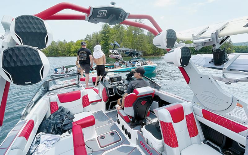 Malibu Boats company officials and professional athletes and models rendezvous in Lake Santeetlah on May 18, to compare notes during a lake cleanup. The group is at the lake for two weeks to shoot promotional videos for the premium ski boats. Photos by Randy Foster/news@grahamstar.com