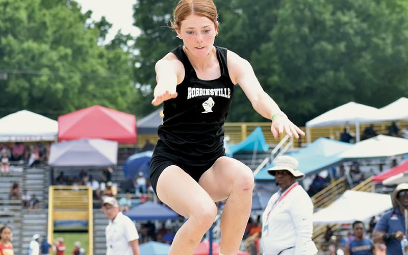 On this attempt, Lady Knights sophomore Zoie Shuler broke the 1A state record in the triple jump, setting a new standard of 39 feet, 9 ¼ inches at Saturday’s championship meet in Greensboro. It was her second state championship of the day. Photos by Kevin Hensley/sports@grahamstar.com