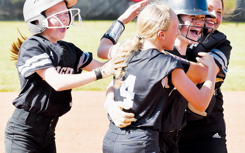 Robbinsville Middle School’s Daphne Barlow (second from right) is mobbed by teammates Kynadee Spencer, Khaygen Buchanan and Dreylee Webster (from left) after her walk-off hit May 11 against Cherokee, which lifted Robbinsville to a 2-1 victory in the season finale. Photos by Kevin Hensley/sports@grahamstar.com