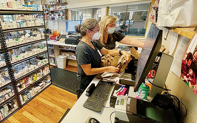 Pharmacist Dana Tanaka (left) and Pharmacy Technician Tonya Howell fill prescriptions at the Appalachian Mountain Community Health Center pharmacy on April 27.