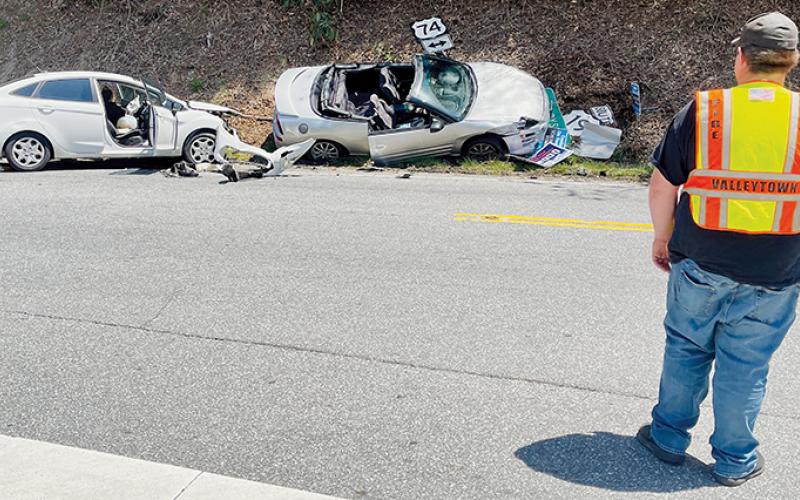 A firefighter from Valleytown Fire Department in Andrews helps direct traffic at a collision in Topton on April 28. Photo by Randy Foster/news@grahamstar.com