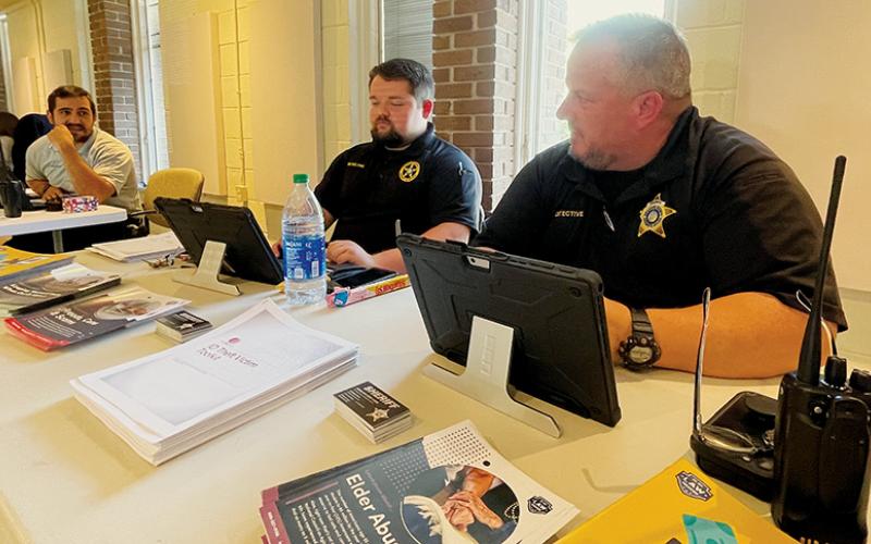 EMT Hamilton Boxberger, sheriff’s Detective Andrew Bennett and Sheriff’s Capt. Jeff Knight (from left) provide information about services their agencies provide  during the Adult Services Resource Fair on June 15 in Robbinsville. Photo by Randy Foster/news@grahamstar.com
