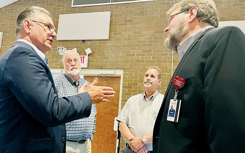 State Rep. Karl Gillespie (R-Macon), the Rev. Eric Reece, Graham County Commissioner Lynn Cody, and AdventistHealth representative Graham Fields (from left) discuss AdventHealth’s proposal to build a 67-bed hospital in Buncombe County. Graham County is within Buncombe County’s hospital service area. Photo by Randy Foster/news@grahamstar.com