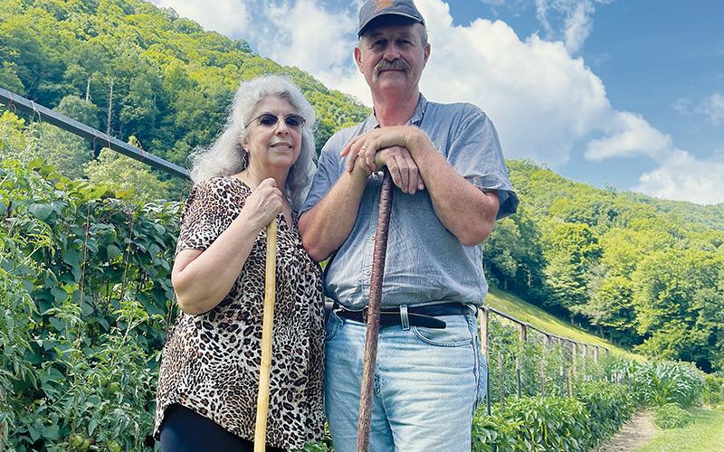 Brenda and Harold Williams pose beside their Beech Creek garden July 18. Photos by Randy Foster/news@grahamstar.com