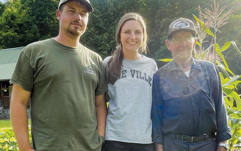 Cameron and Hannah Anderson (left) stand with Hannah’s grandfather Billy Holder, who is helping them with their garden off Lower Stecoah Road. Photos by Randy Foster/news@grahamstar.com