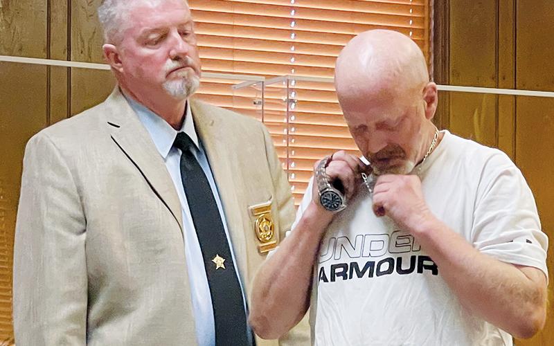 Graham County Jail Adminstrator Marlon Jackson (left) looks on as Bryan Aaron Berryman turns in his necklace and watch in Graham County Superior Court on July 13. Berryman had just been sentenced to between 11-15 ½ years in prison for a litany of charges obtained in an April 2021 arrest. Photo by Randy Foster/news@grahamstar.com