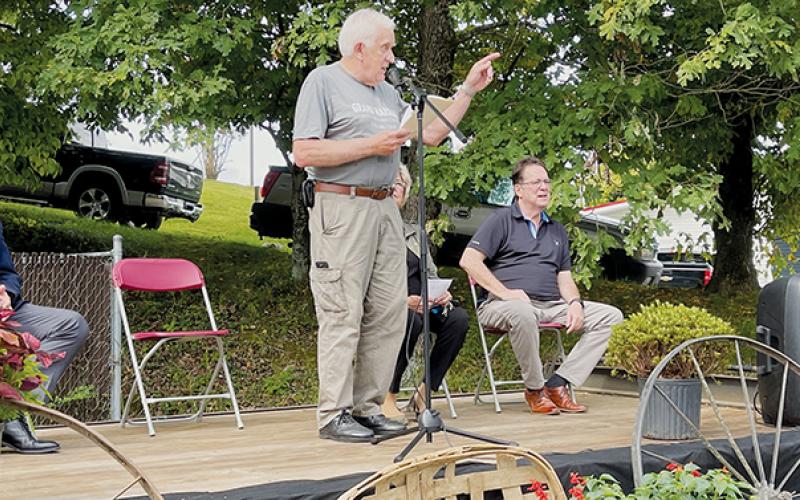 Flanked by N.C. 120th District Rep. Karl Gillespie (R-Macon) and N.C. Senate District 50 Rep. Kevin Corbin (R-Macon), Grand Marshal Marshall McClung addresses the crowd during the second day of Graham County’s 150th anniversary celebration.