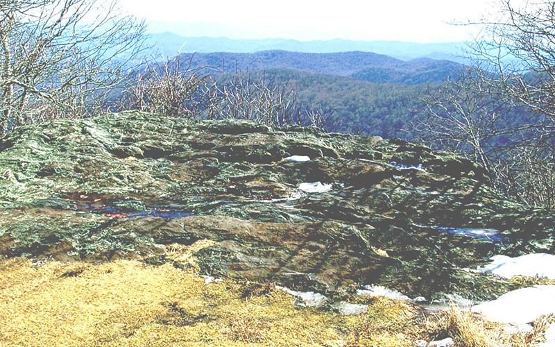 This large rock on Hooper Bald is inscribed with writing dating to 1615. Photo by Marshall McClung/The Graham Star