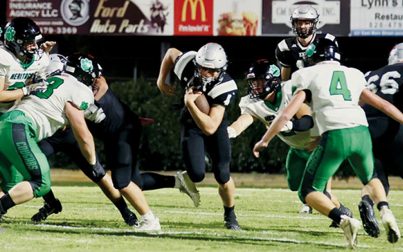 Emerging from a battle at the line, junior running back Cuttler Adams makes another run into the record books Friday. Adams now has 3,085 rushing yards in his varsity career.