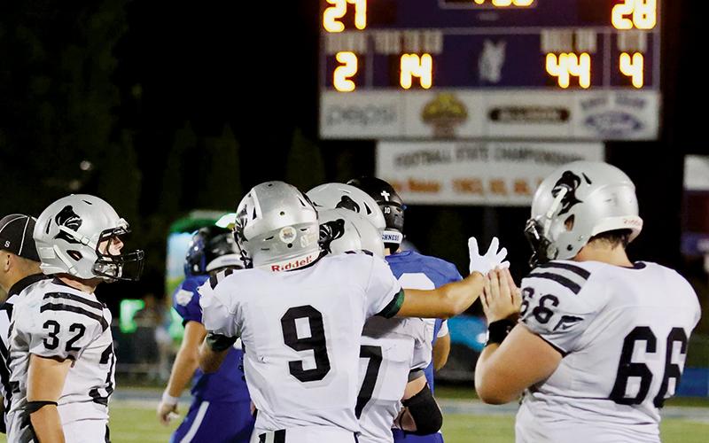 With the final outcome solidified on the scoreboard, Robbinsville’s Jude Campbell (32), Carson Lovin (9), Turner Jackson (7) and Haden Key (66) swarm Brock Adams after his victory-clinching interception Friday at Smoky Mountain. Photos by Miranda Buchanan/Robbinsville High School Yearbook