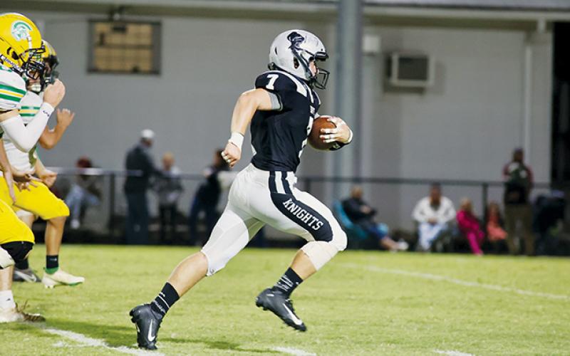 Not a Trojan was found in the path of senior fullback Turner Jackson on Friday, as he began a 58-yard scoring sprint during the Knights’ 40-7 squashing of Alleghany. Photo by Miranda Buchanan/Robbinsville High School Yearbook