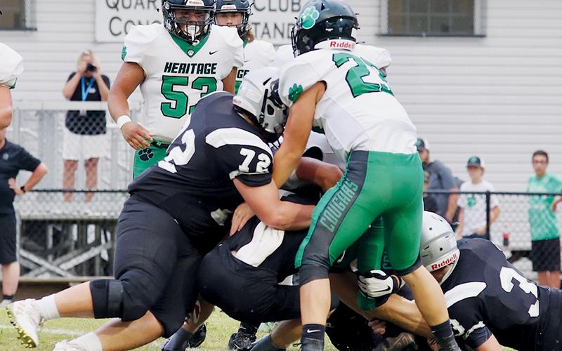 Robbinsville defenders – led by Tytan Teesateskie (72) and Caleb Draper (3) shut down the progress of Mountain Heritage quarterback Griffin Ray on Friday. For the second-straight week, the Knights’ defense held the opposition to single-digits, as Robbinsville picked up a 26-8 victory. Photos courtesy of Miranda Buchanan/Robbinsville High School Yearbook