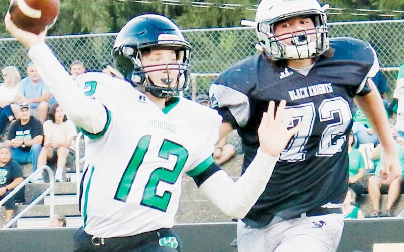 Black Knights’ lineman Dane Daniels (72) pursues Mountain Heritage quarterback Brayden Deyton during Aug. 25’s game against the Cougars. Photo courtesy of Carlos Lopez/Robbinsville High School