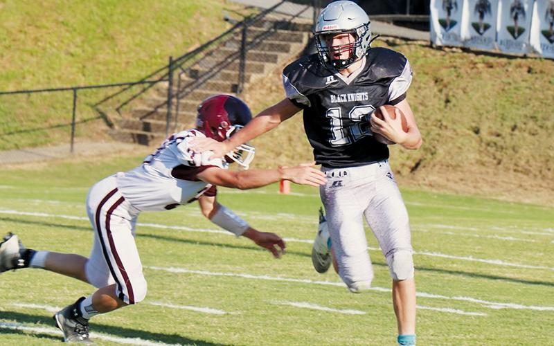 JV Black Knight Tillman Adams (12) lays waste to a would-be Swain County defender during Robbinsville’s 12-8 loss to the Maroon Devils on Sept. 1. Photo courtesy of Carlos Lopez/Robbinsville High School