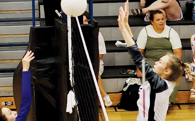 The work of Robbinsville’s younger varsity players – including Claire Barlow, shown contesting a Highlands return Aug. 23 – was crucial to the Knights’ clinching a four-set victory over Cherokee on Tuesday. Photo courtesy of Miranda Buchanan/Robbinsville High School Yearbook