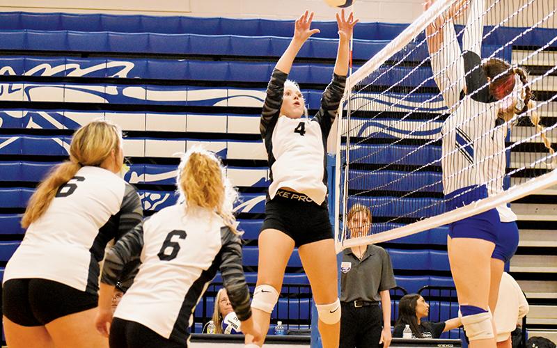 Lady Knights senior Kensley Phillips attempts some chicanery on the Lady Mustangs’ defense with a last-second push Monday.
