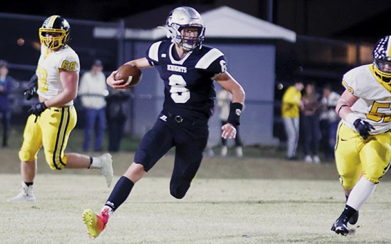 Sophomore quarterback Bryce Adams (6) finds some open room to advance during Friday’s loss to Murphy. Photo by Miranda Buchanan/Robbinsville High School Yearbook