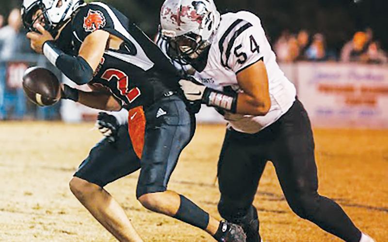 Senior lineman Carlos Lopez (54) attempts to bring down Andrews quarterback Donovan Carpenter during Robbinsville’s foray against the Wildcats on Friday. Photo courtesy of Haley Coffey