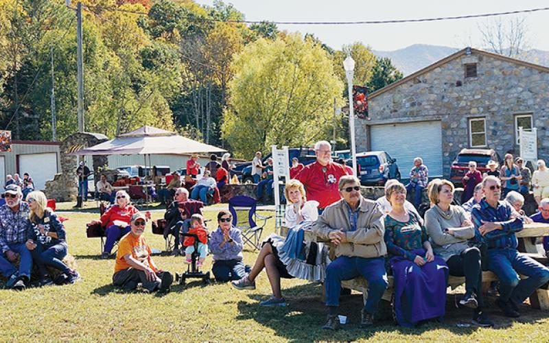 An audience watches a performance by the Oktober Fest Dancers at the festival.