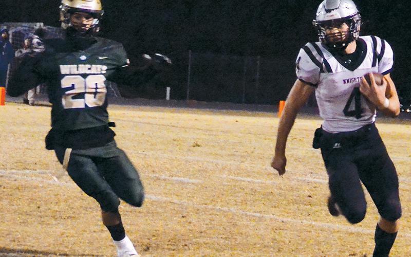 Cuttler Adams (4) dashes around the pursuit of Eastern Randolph’s Pierce Leonard on a second-half run Friday. Adams eclipsed 200 rushing yards in the game, but Robbinsville fell 29-26 to the Wildcats in the third round of the state playoffs. Photos by Kevin Hensley/sports@grahamstar.com