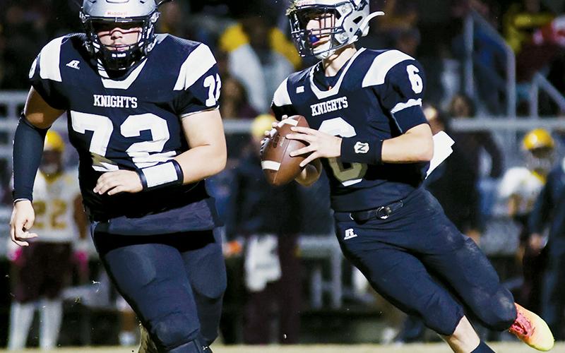 Led by the protection of classmate Tytan Teesateskie (72), Robbinsville sophomore quarterback Bryce Adams scans his downfield options Nov. 10 against Cherokee. Bryce completed eight passes – two for touchdowns to his brother, Brock Adams – and collected 131 yards in the Knights’ 39-12 second-round playoff victory over the Braves. Photos courtesy of Miranda Buchanan/Robbinsville High School Yearbook