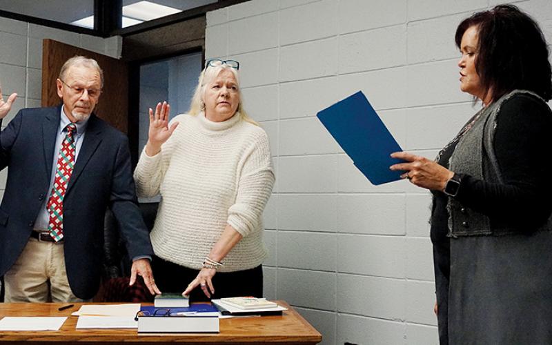 Clark “Chip” Carringer and Debra “Hank” Dinschel recite oaths of office administered by Graham County Clerk of Court Tammy Holloway at a special-called meeting of the Graham County Board of Education on Tuesday evening. Photo by Randy Foster/news@grahamstar.com