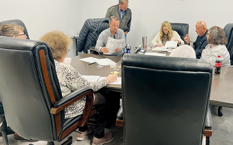 The Graham County Board of Elections sifts through ballots from the Nov. 8 election Friday, during a requested hand-to-eye recount in the race for the second seat on the Graham County Board of Education. Clockwise from top are board chair Juanita Colvard; board members Beefy Rogers and Teresa Eller; poll workers Tracy Jenkins and Lorna Sellers, who tallied the recount; local election director Teresa Garland; and board members Billy Ditmore and Lowell Crisp. Photo by Kevin Hensley/editor@grahamstar.com