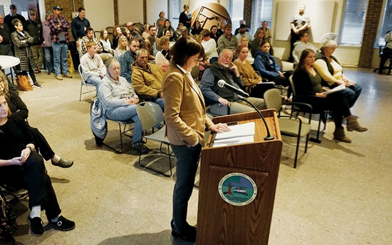 Becky Garland – standing at the podium during a Board of Health meeting on Nov. 21 – is a Cherokee County resident and Graham County Government finance director. She clocked out from her job so that she could argue on behalf of family planning services. Photo by Randy Foster/news@grahamstar.com