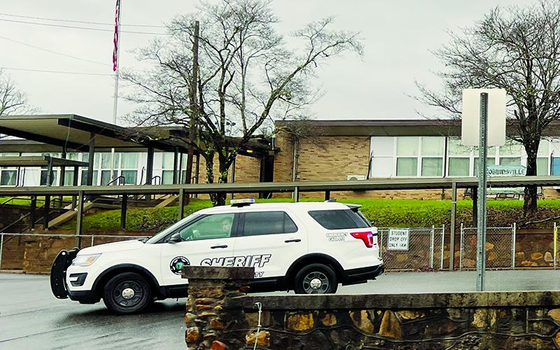 A Graham County deputy is shown stationed outside Robbinsville Elementary School on Dec. 7, after a bomb threat was phoned into the district’s tip line earlier that morning. Graham County Schools were shut down for the day as a safety precaution, with both sheriff’s deputies and state troopers protecting entrances to the schools until the situation was investigated. Photo by Kevin Hensley/editor@grahamstar.com