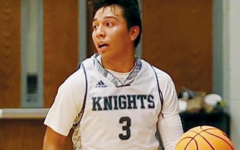 Xander Wachacha searches for an open player during Nov. 30’s season opener against Smoky Mountain. Wachacha’s 19 points led the Black Knights in an overtime win over the Mustangs, before the junior guard unloaded a team-best 22 points against Highlands on Tuesday. Photo courtesy of Miranda Buchanan/Robbinsville High School Yearbook