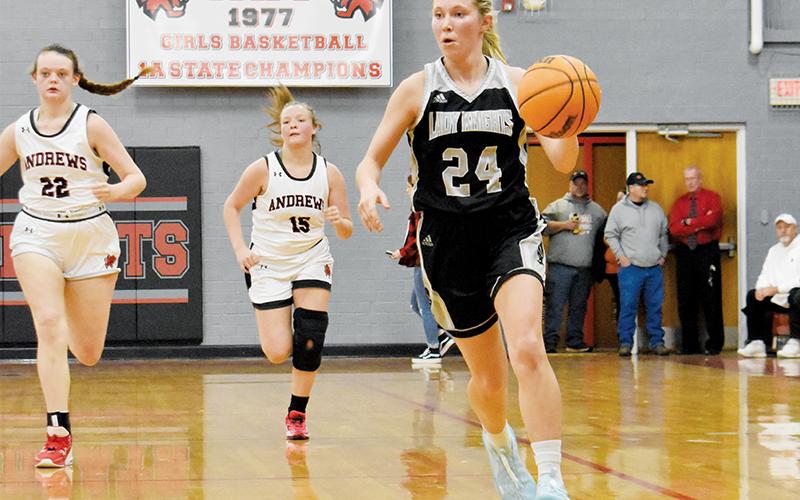 Lady Knights senior Kensley Phillips pulls away from the  defensive pursuit of Andrews’ Gracelyn Worley (22) and Demi Davis (15) on Tuesday. Photo by Kevin Hensley/sports@grahamstar.com