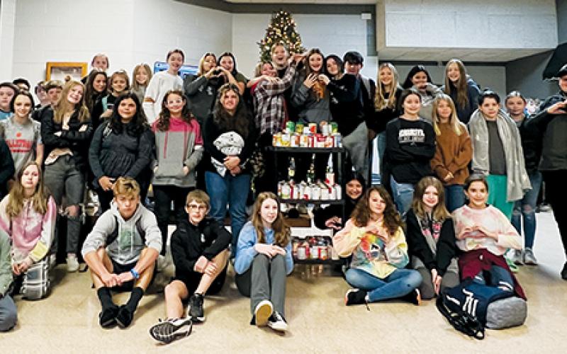 Robbinsville Middle School students assigned to the “Amistad” (Red) House gather around the 100-plus cans collected to help combat local hunger. Photo by Kevin Hensley/editor@grahamstar.com