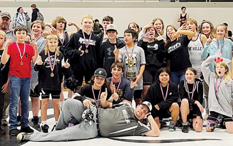 The Robbinsville Middle School wrestling team gathers to celebrate its 2022-23 Smoky Mountain Conference  tournament championship Dec. 15, moments after winning the title on their home mat.
