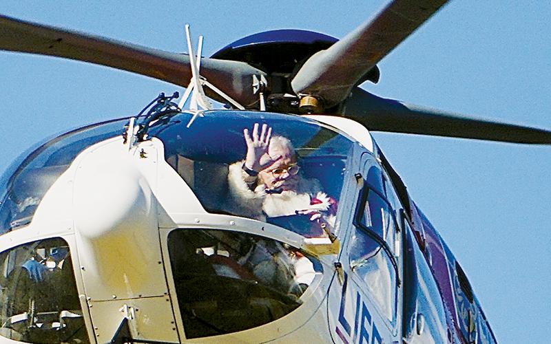 Santa Claus greets exuberant Robbinsville Elementary School children after  hitching a ride on a helicopter and landing on the 50-yard line at Big Oaks Stadium on Dec. 15. Photos by Randy Foster/news@grahamstar.com