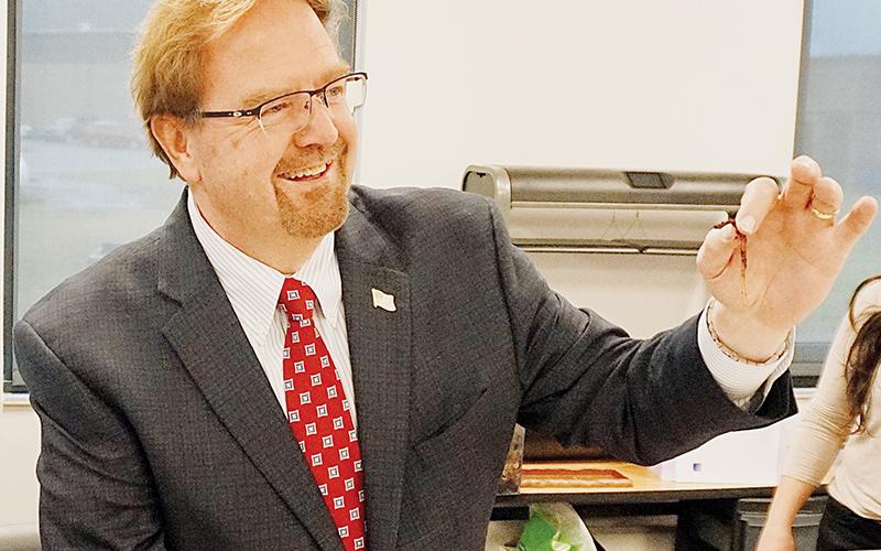 U.S. Rep. Chuck Edwards examines a worm in an agriculture class during his tour of Robbinsville Middle School on Tuesday.
