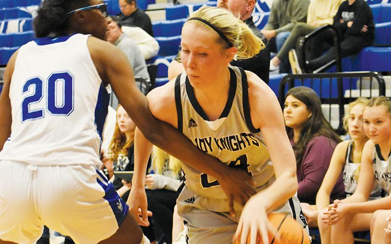 Robbinsville senior Kensley Phillips (right) drives past Brevard’s Shaniya Cook during Dec. 29’s Smoky Mountain Christmas Invitational appointment with the Lady Devils. The Lady Knights’ shooting guard was all over the floor in the lopsided victory,  picking up her first career triple-double in the process. Photos by Kevin Hensley/sports@grahamstar.com